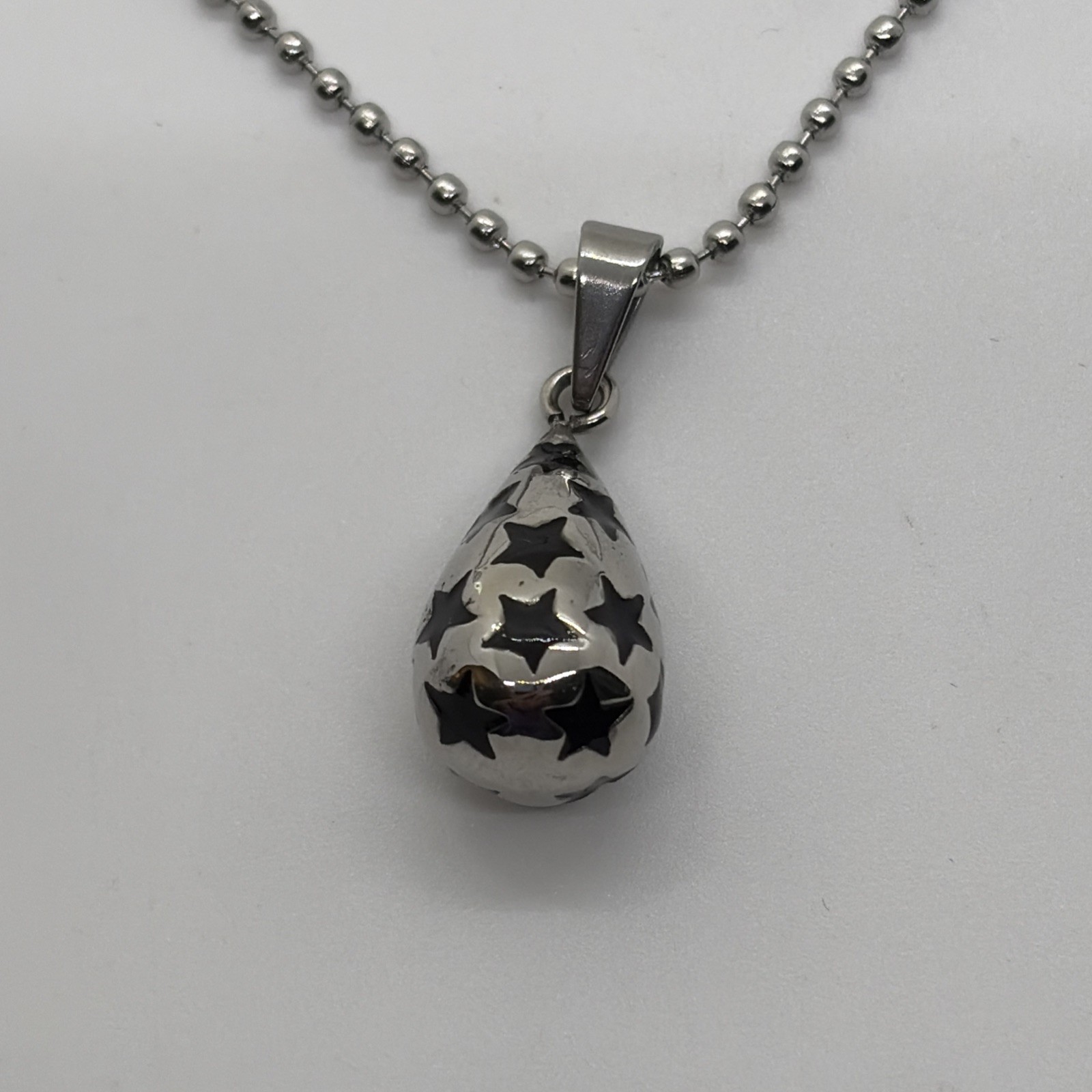 Stainless Steel Pendant With Silver And Black Charm With Stars On A 23” Chain