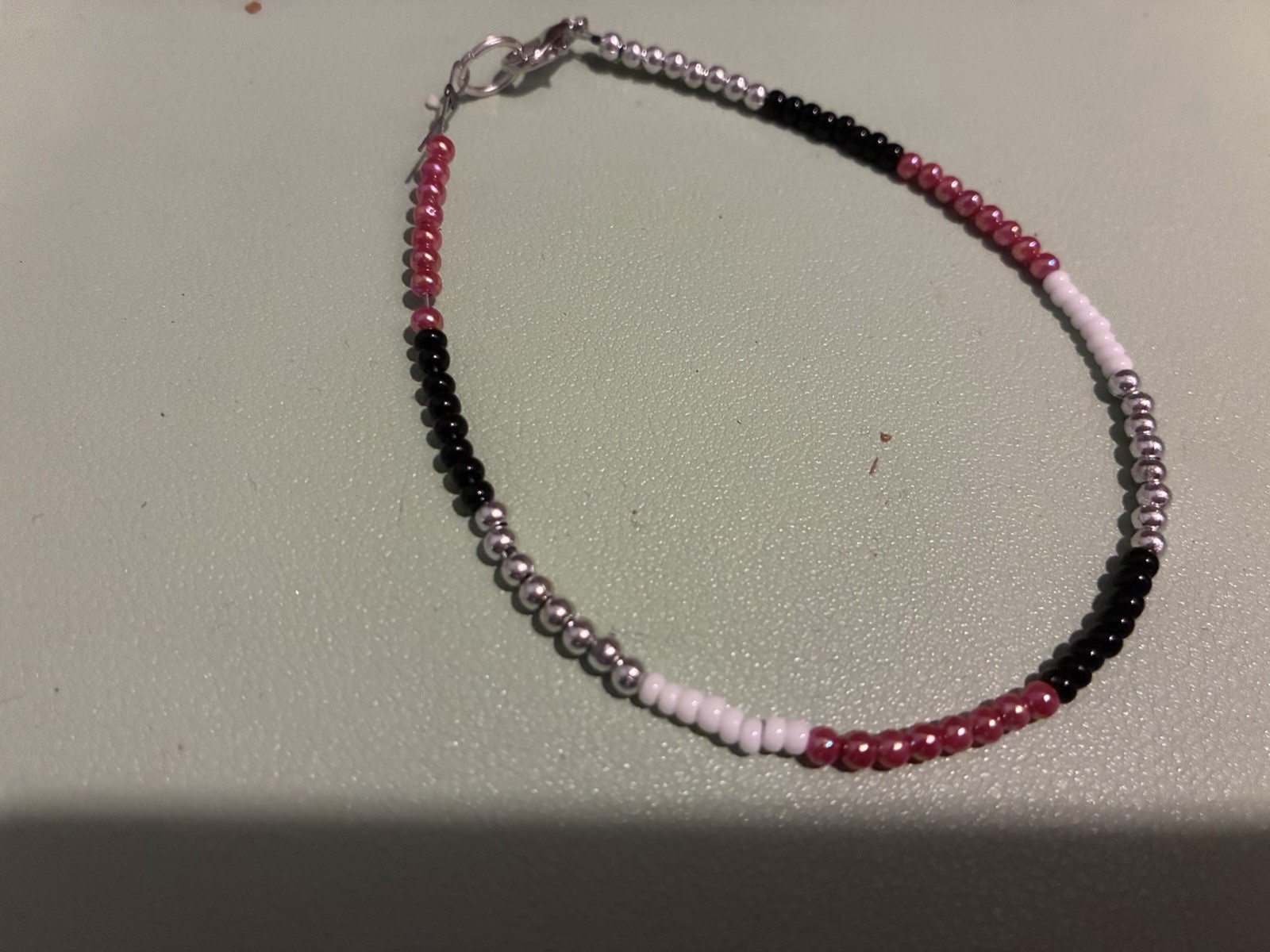 Multicolor Glass Beaded Bracelet with Lobster Clasp Closure.