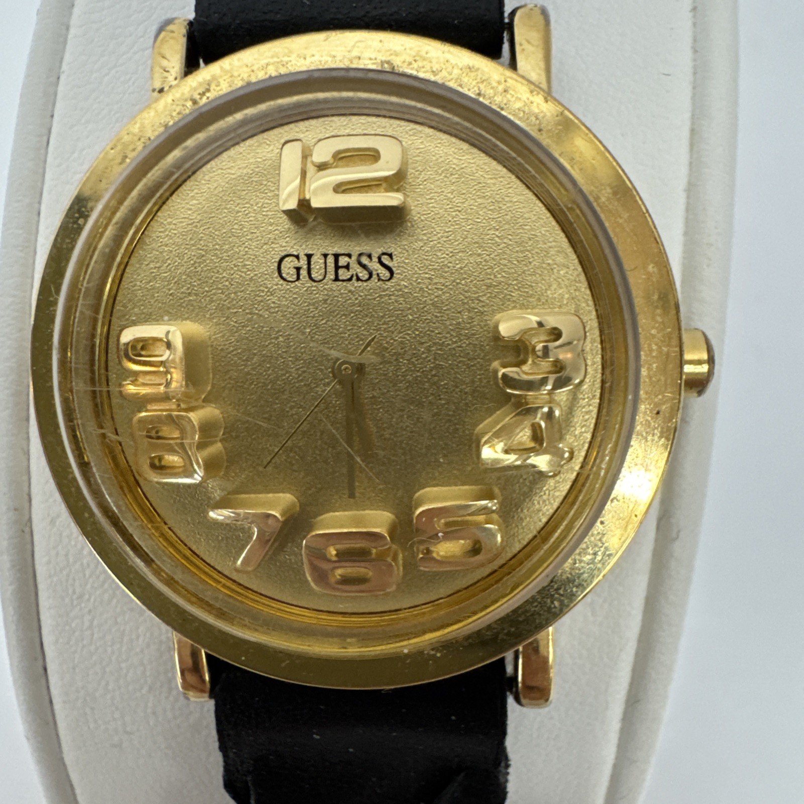 Vtg Guess watch gold-tone & raised 3D numbers and a black braided leather band.