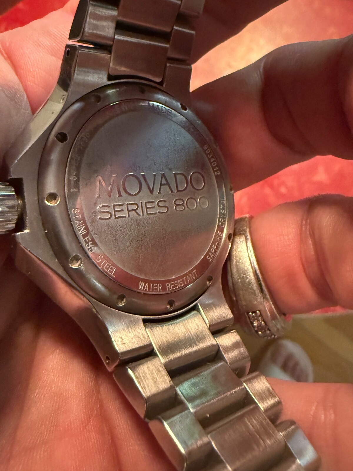 MOVADO 800 SERIES WATCH WITH BLCK BEZEL AND DIAMOND MAKERS – MENS WATCH