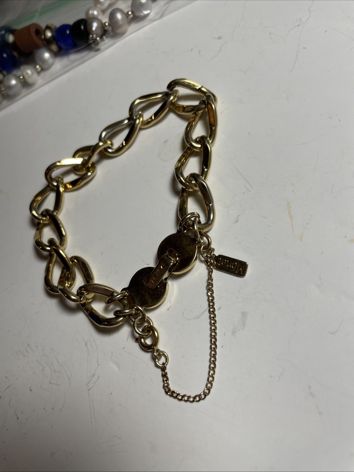 Monet GOLD tone link bracelet with safety chain