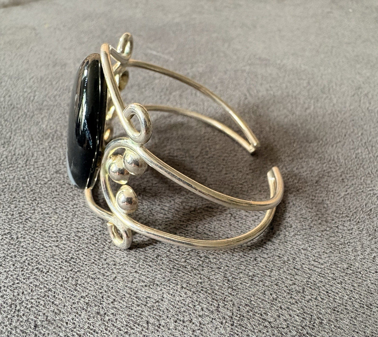 Silver wire cuff bracelet with circular dichroic glass black/gray cabochon