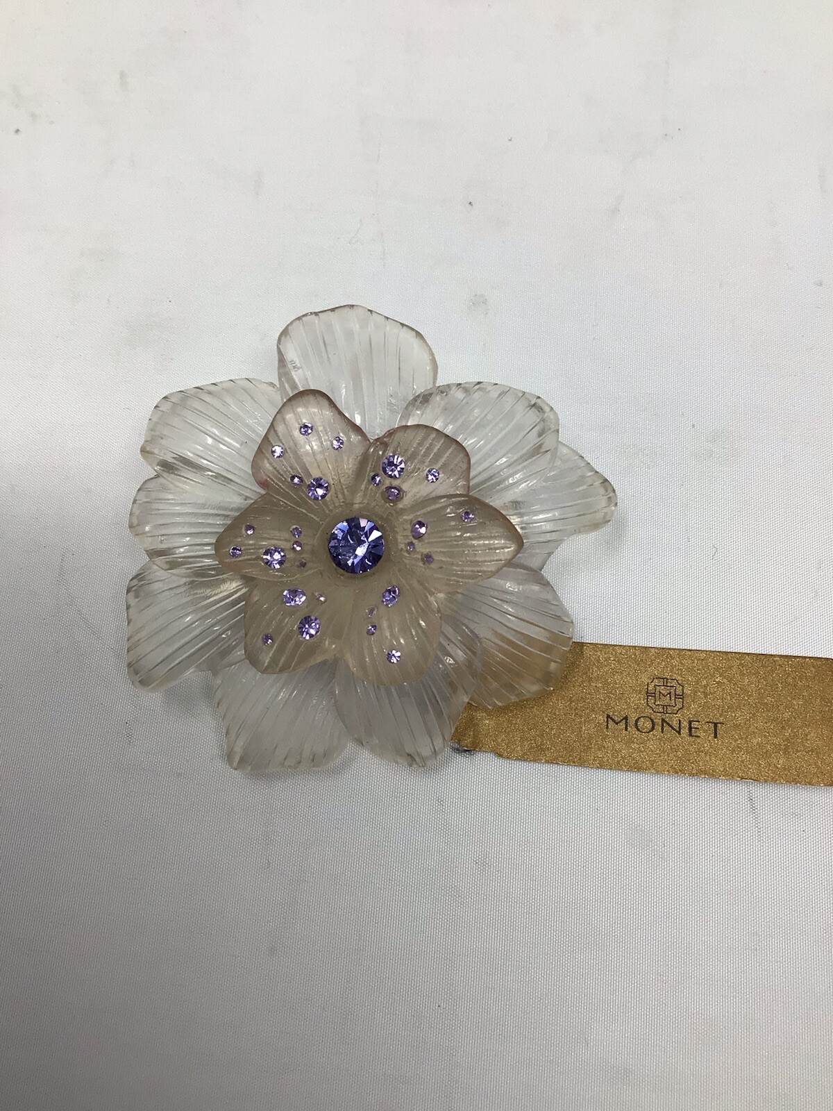 Monet Translucent lucite/plastic molded flower brooch with lavander rhinestone
