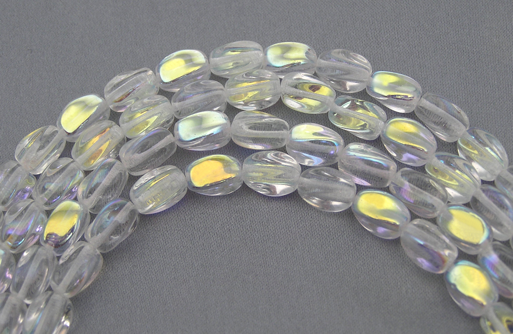 23 Czech Glass Druk Beads 9x7mm Crystal AB twisted oval, pressed, clear AB, P203