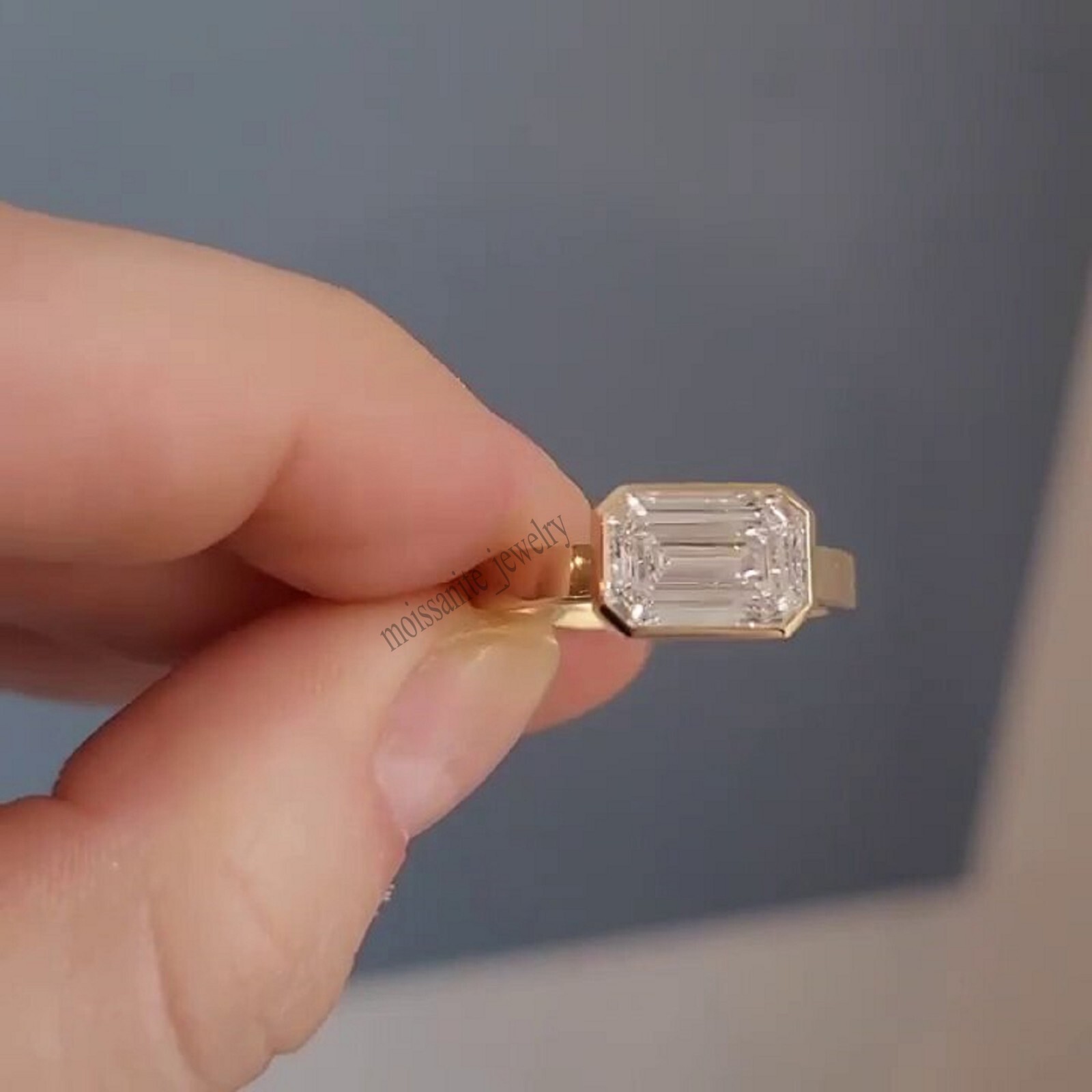 East West Bezel Set 1.70 Carat Emerald Cut White Moissanite Ring 10k Yellow Gold