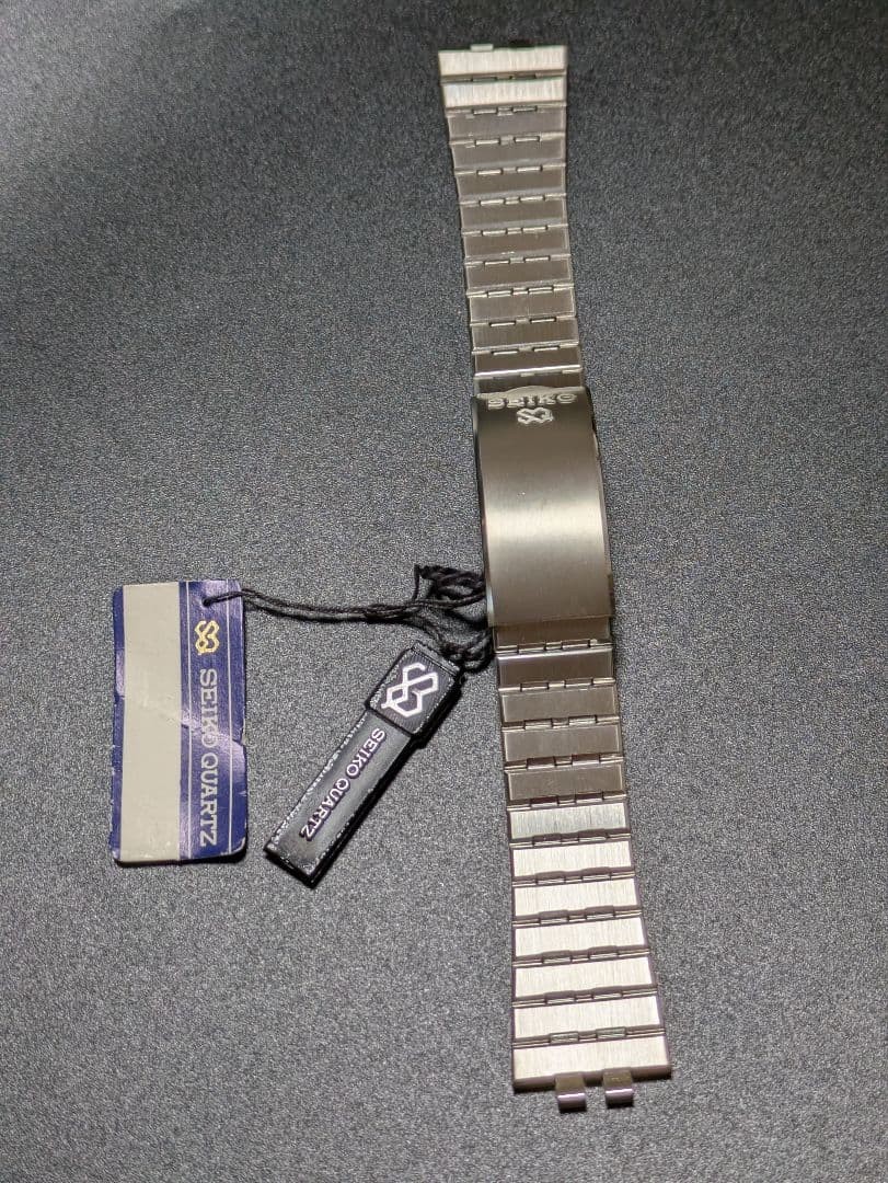 SEIKO stainless steel simple metal band with tag.