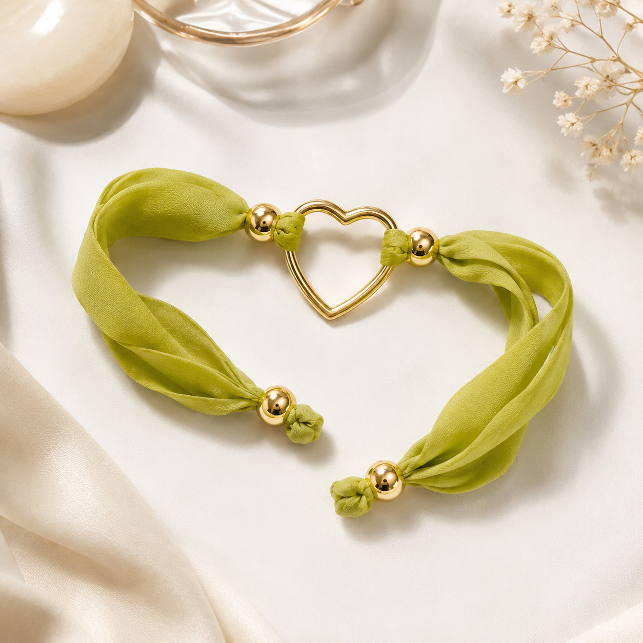 Elegant lime green satin bracelet featuring a delicate gold-tone heart