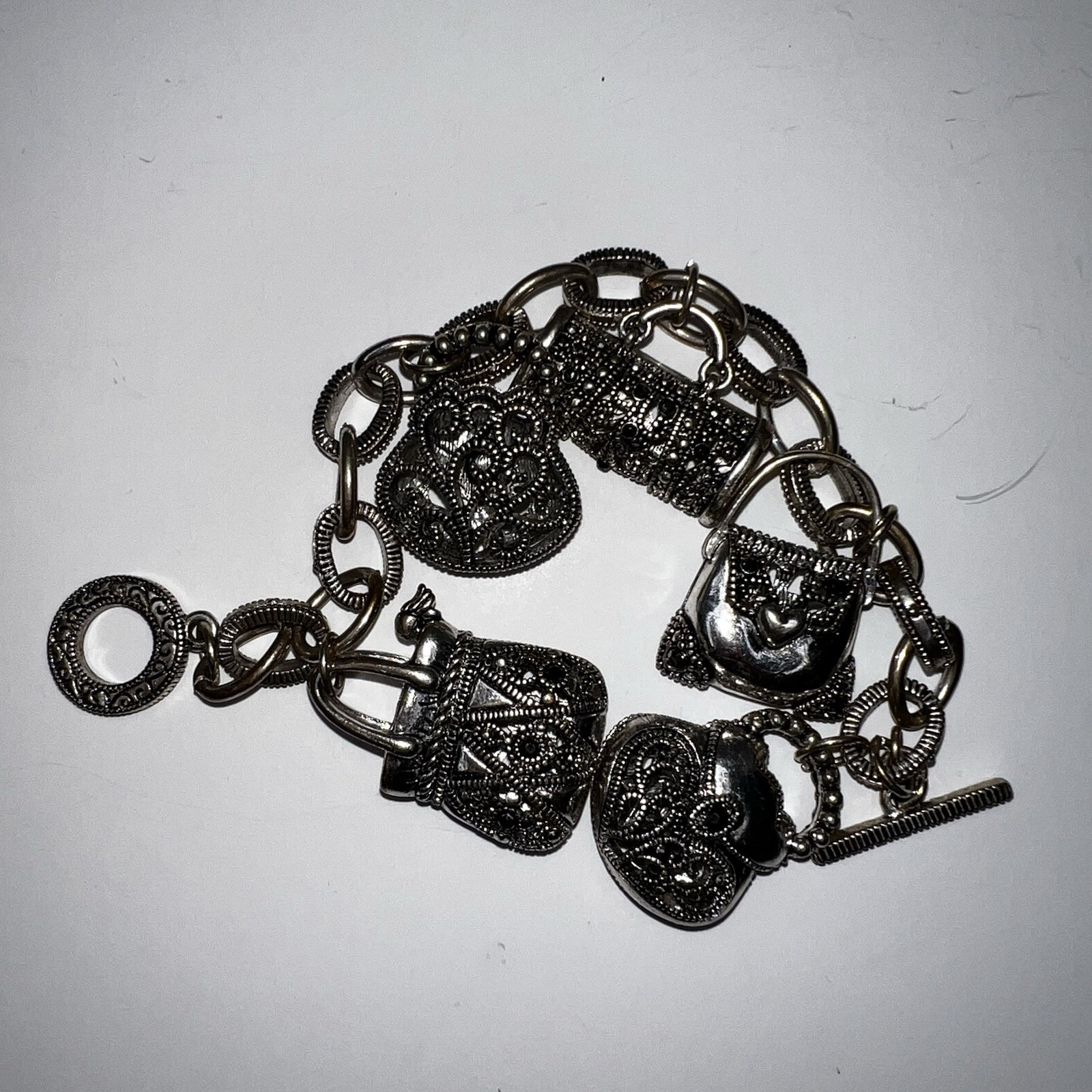 Silver-Tone Metal Puffy Openwork Purse Rhinestone Accent Charm Bracelet toggle
