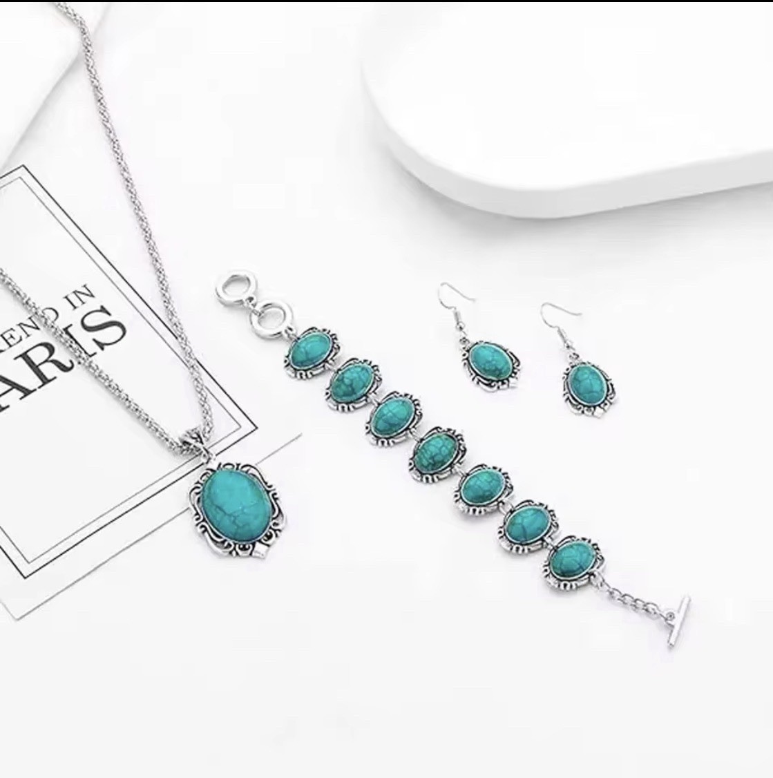 The jewelry set includes a matching necklace, earrings, and bracelet,