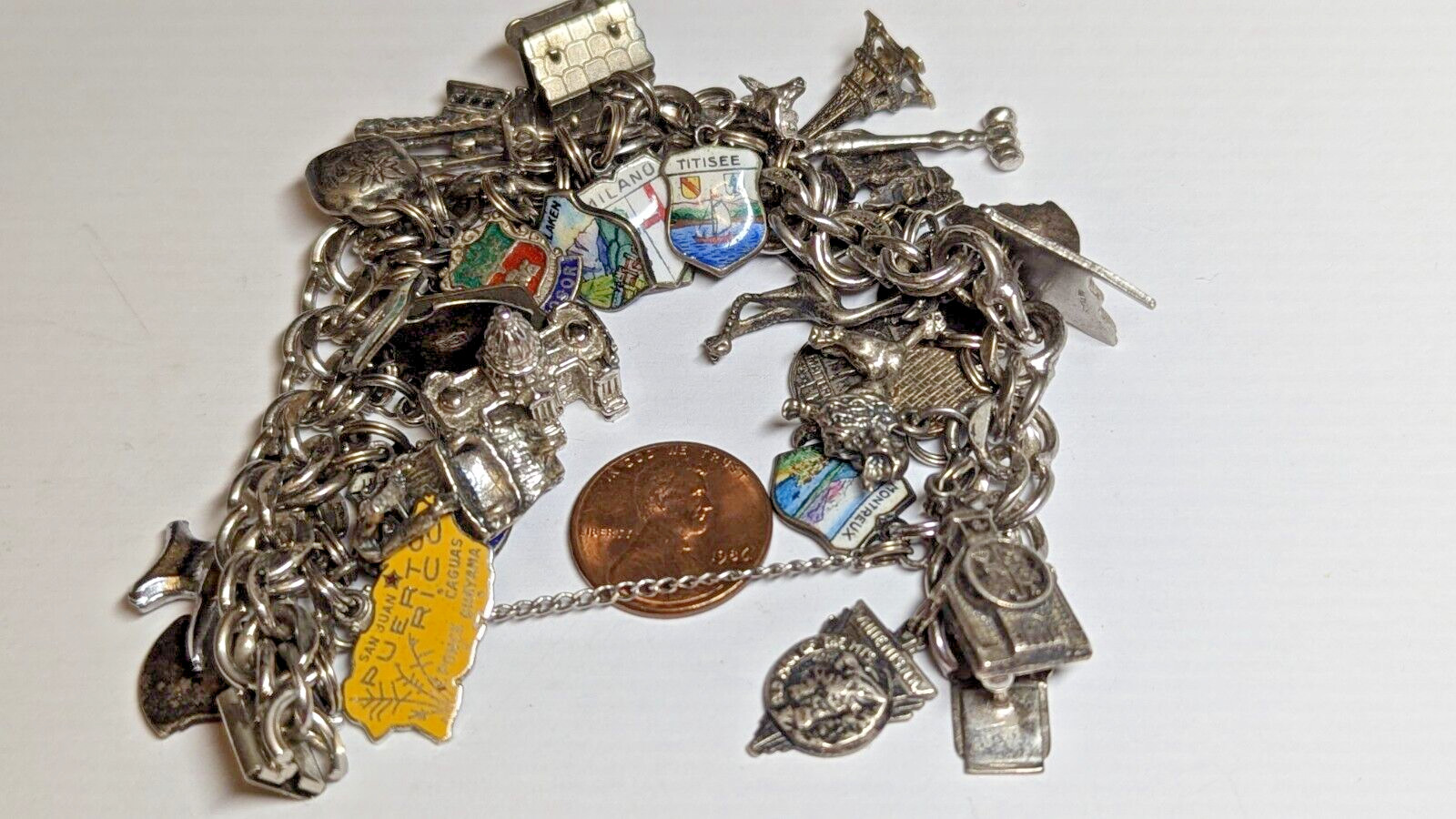 VINTAGE STERLING SILVER CHARM BRACELET WITH ABOUT 35 CHARMS WEIGHS 94.4 GRAMS
