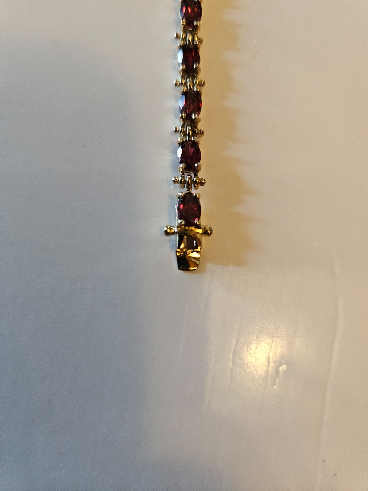 .925 marked with gold tone tourmaline tennis bracelet. Tested by presidium.