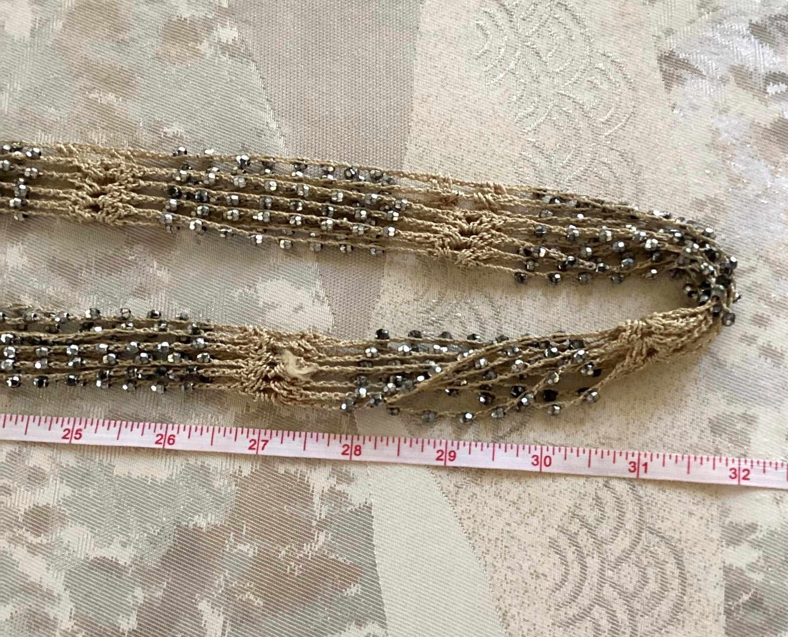 Tan crocheted necklace with silver beads, adjustable, 32 in. long