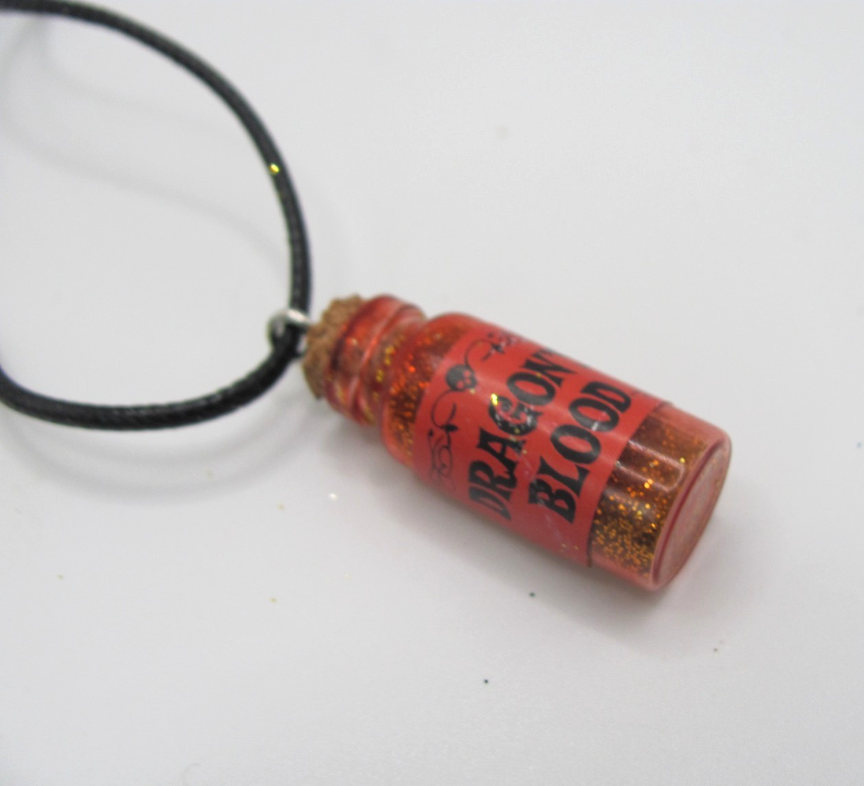 NEW BLACK CORD NECKLACE W/ “DRAGON BLOOD” POTION BOTTLE (ORANGE & RED GLITTER)