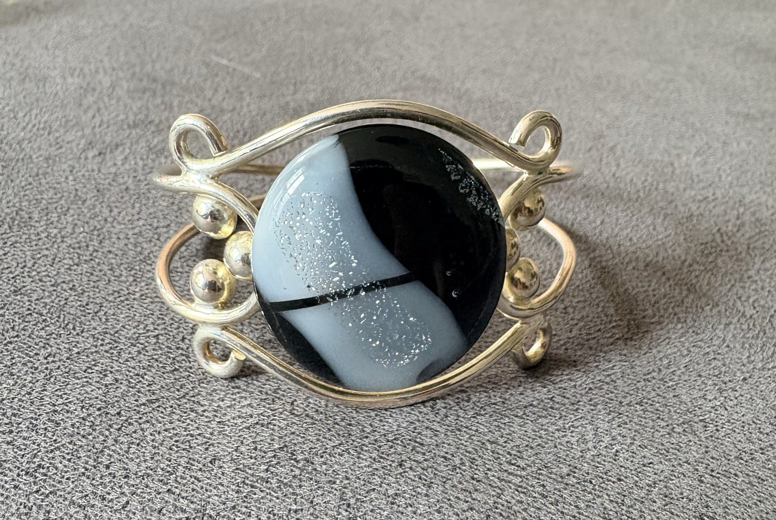 Silver wire cuff bracelet with circular dichroic glass black/gray cabochon