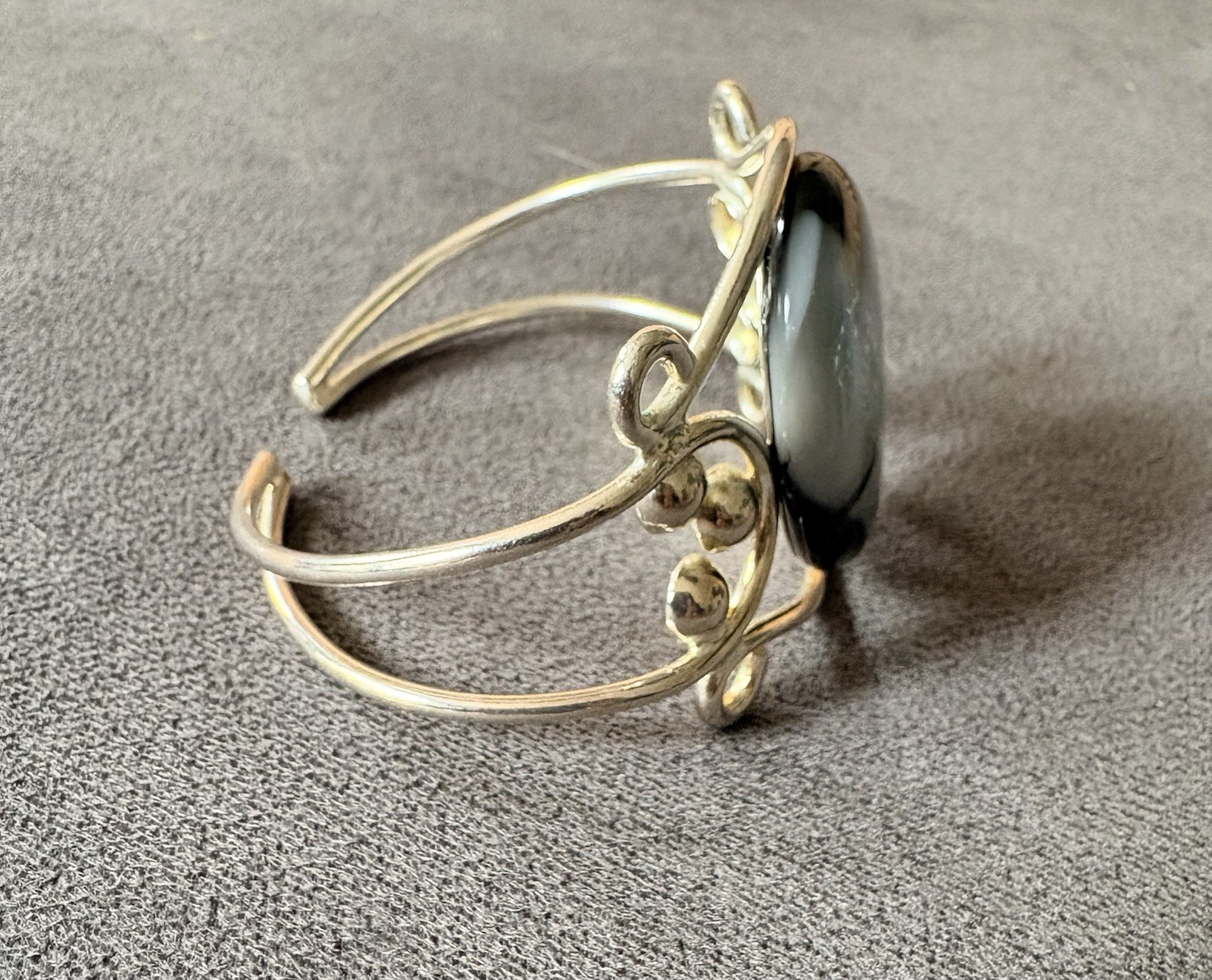 Silver wire cuff bracelet with circular dichroic glass black/gray cabochon