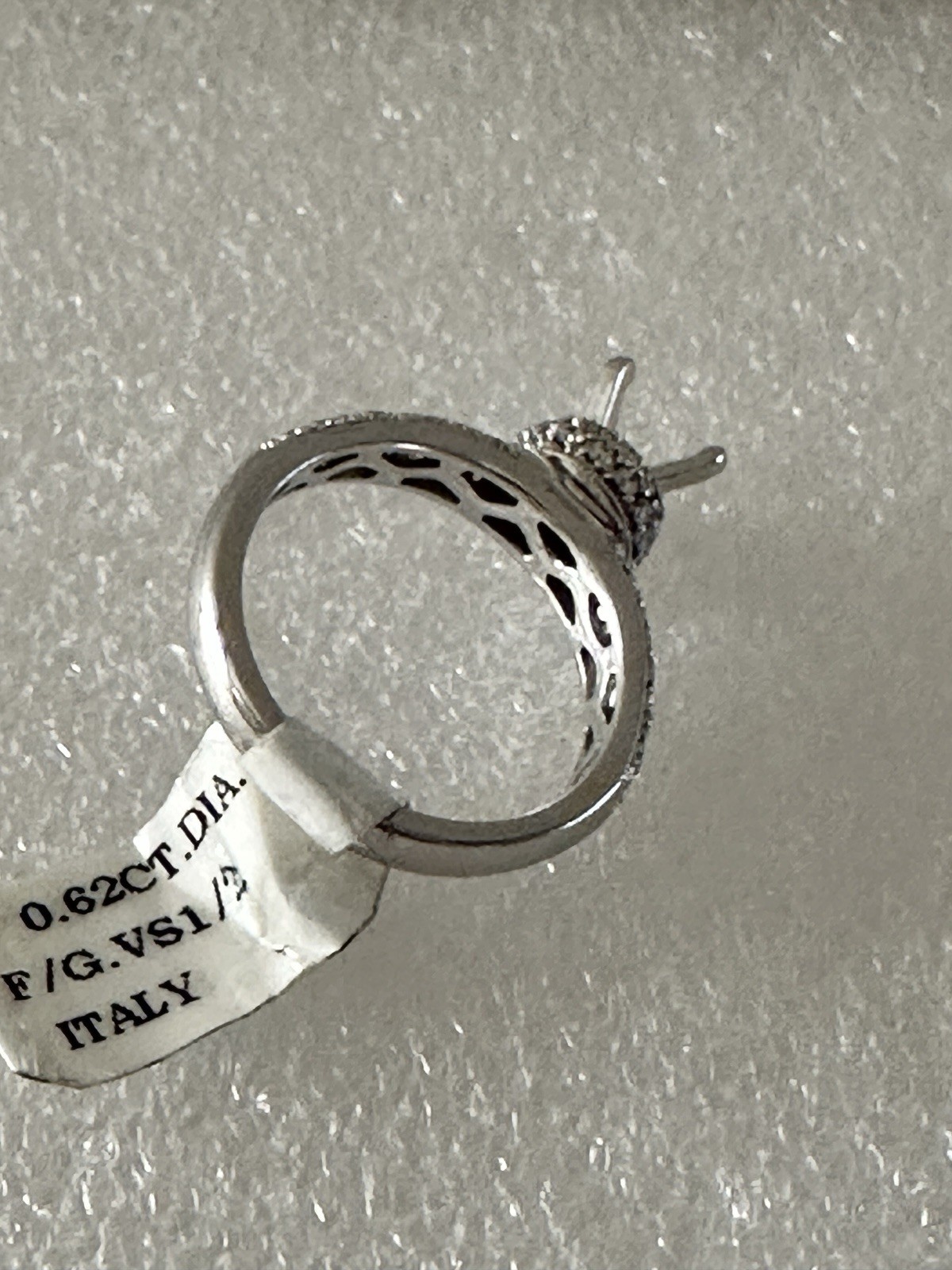 14kt,white gold semi mount ring with 0.62ct, VS2 clarity size 6, 4.40 grams.