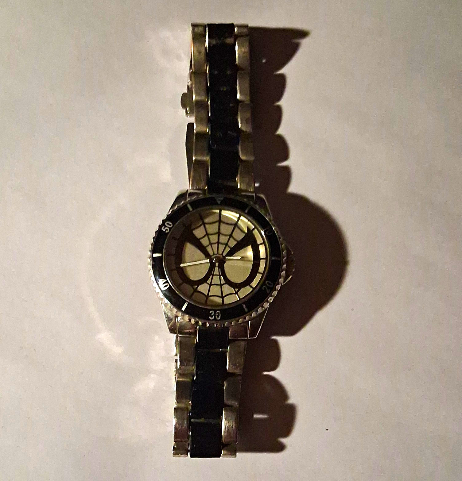 Marvel Men’s Analog Wristwatch Spiderweb Dial Black Fixed Bezel Silver Bracelet