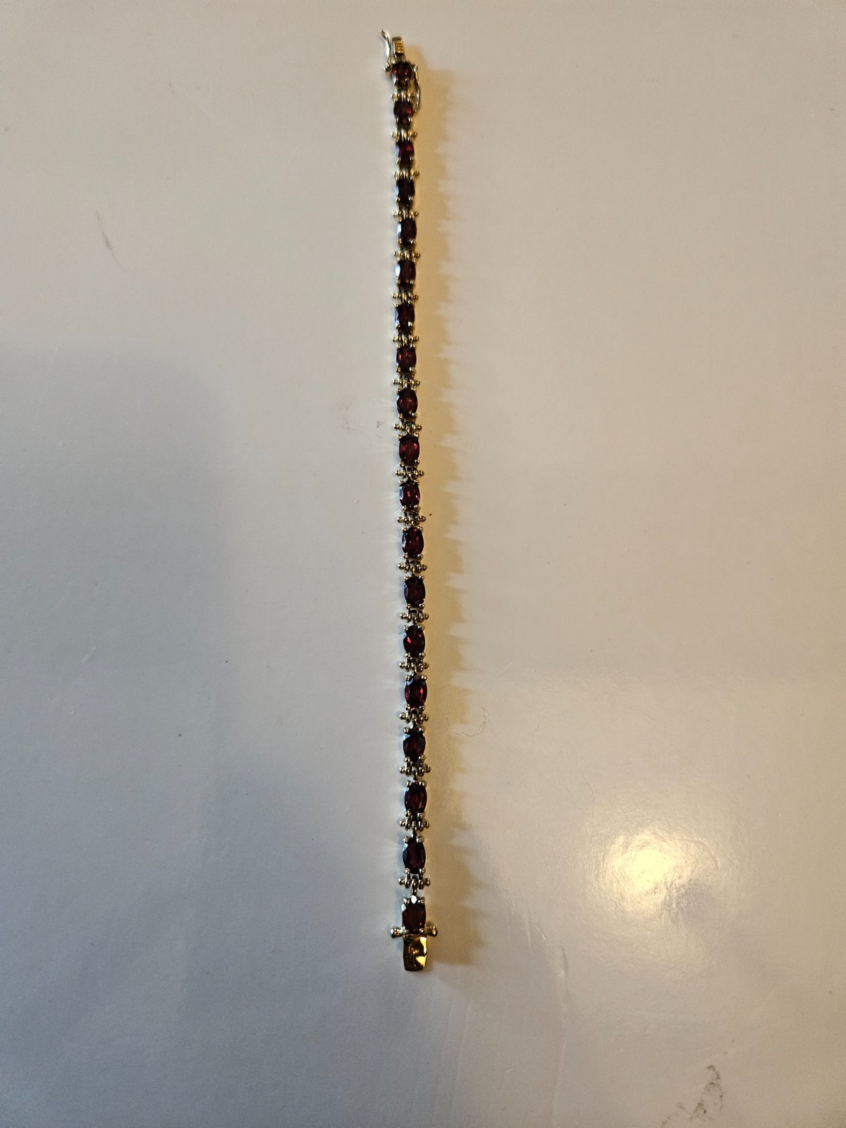 .925 marked with gold tone tourmaline tennis bracelet. Tested by presidium.