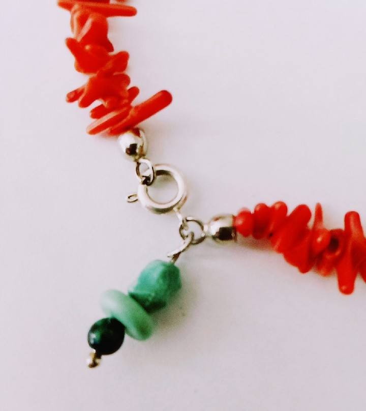 Coral bracelet with a silver clasp closure and a turquoise charm!