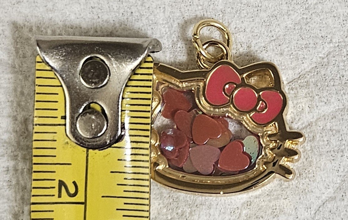 SANRIO HELLO KITTY GOLD TONE HEART CONFETTI SHAKING GLASS PENDANT CHARM
