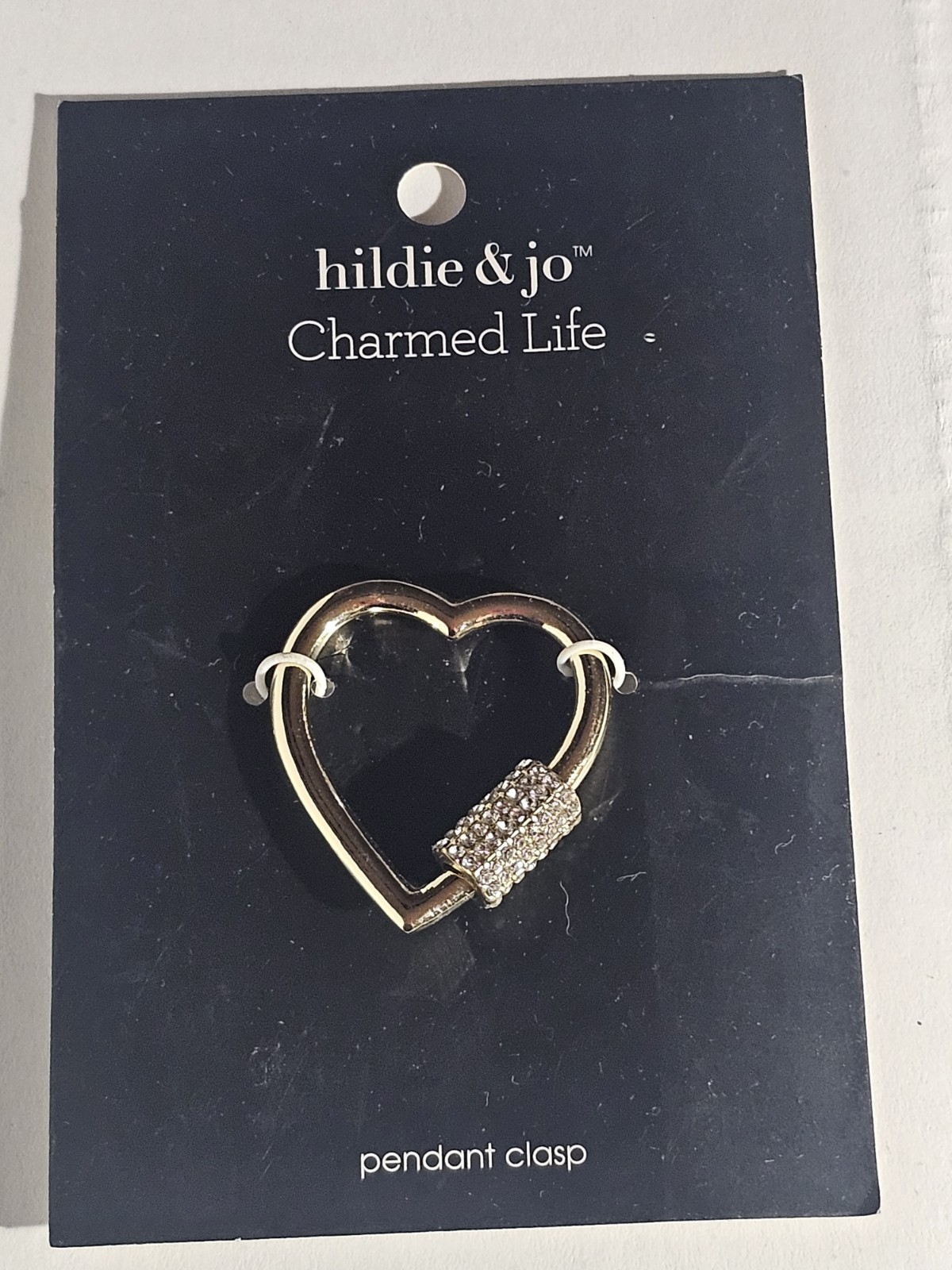 Hildie & Jo “Charmed Life” pendant clasp features a gold-tone heart shape with a