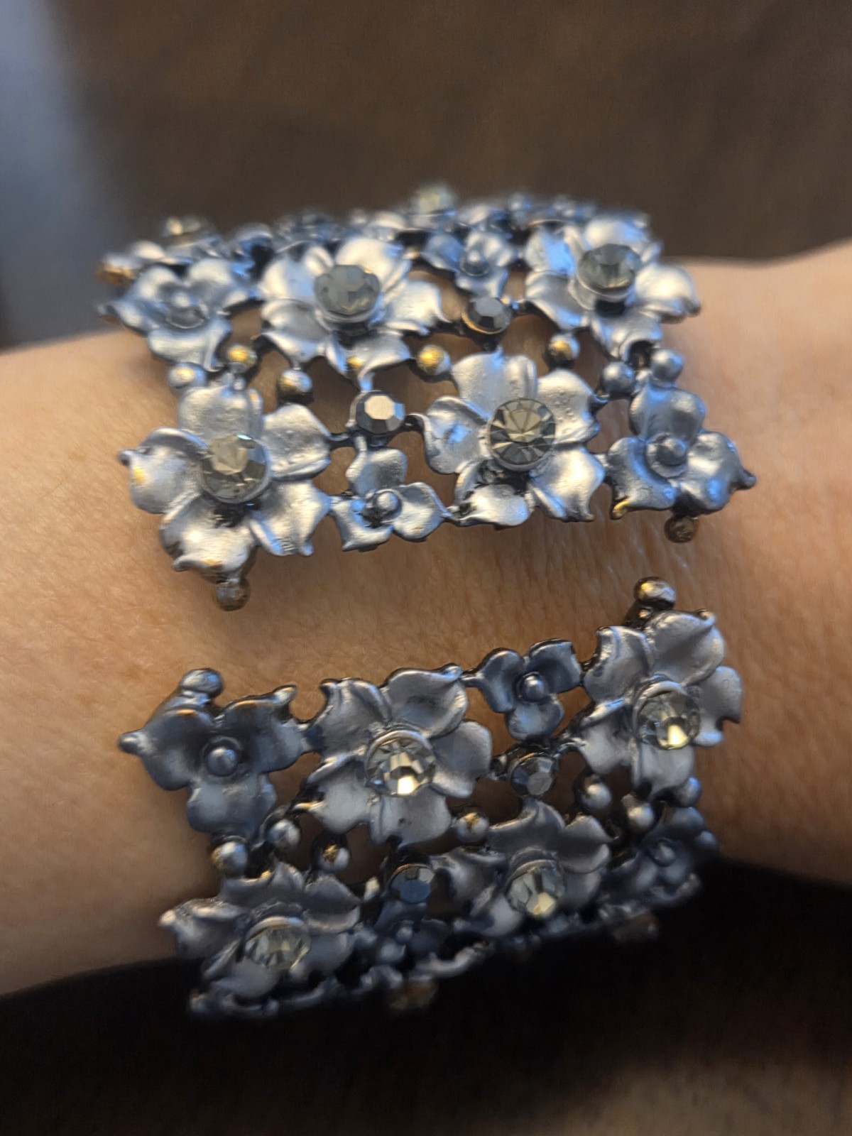 Silver 8 Inch. Metal Stretch Bracelet With Floral Design And Crystal Accents