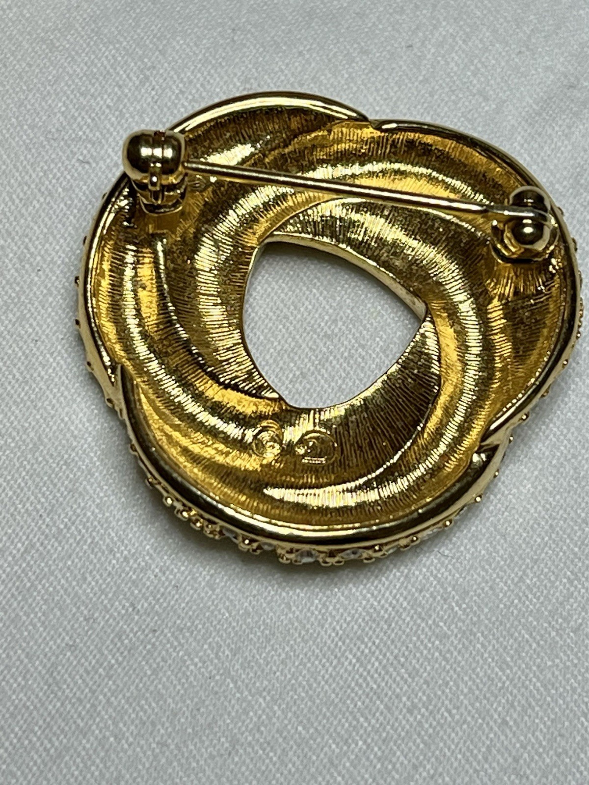 Signed Swarovski Gold Tone Clear Crystal Black Enamel Love Knot Brooch Pin