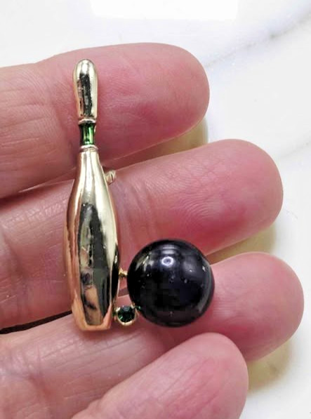 Vintage signed Gerry’s bowling ball brooch. Gold with green rhinestone.