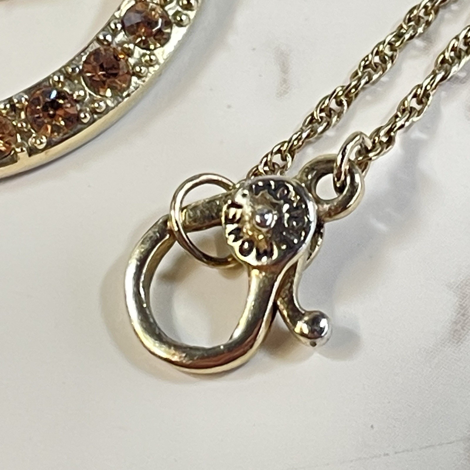 Vintage Monet Gold Tone Topaz Rhinestone Swirl Circle Pendant Necklace Chain 16″