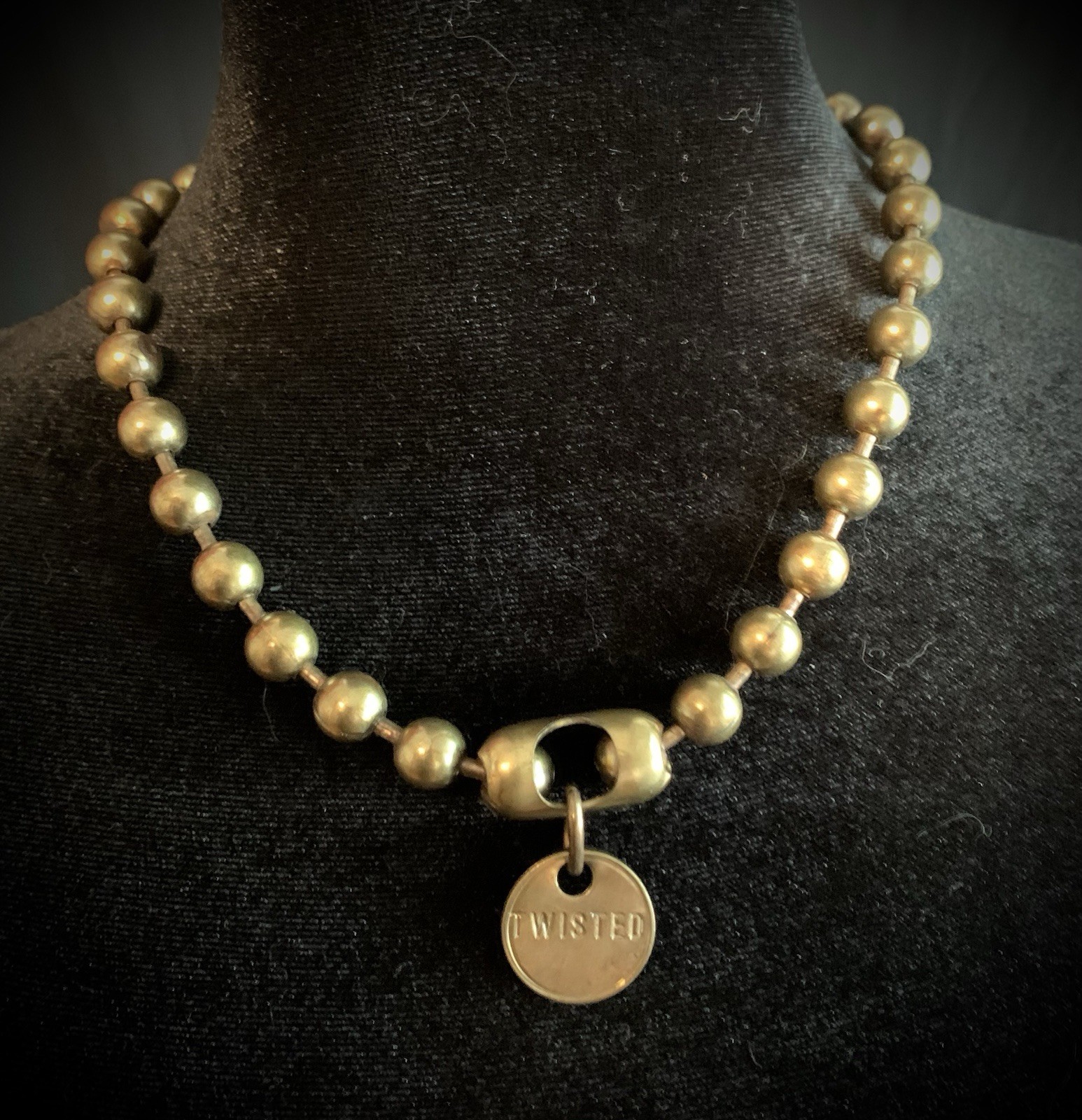 This Twisted Silver ball and chain necklace polished brass beads toggle closure.