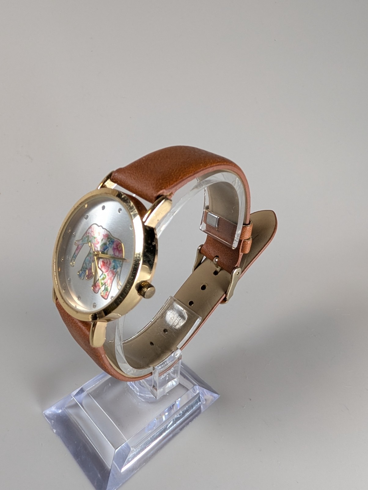 Elephant watch with flower pattern and gold outline and dot indexes brown band
