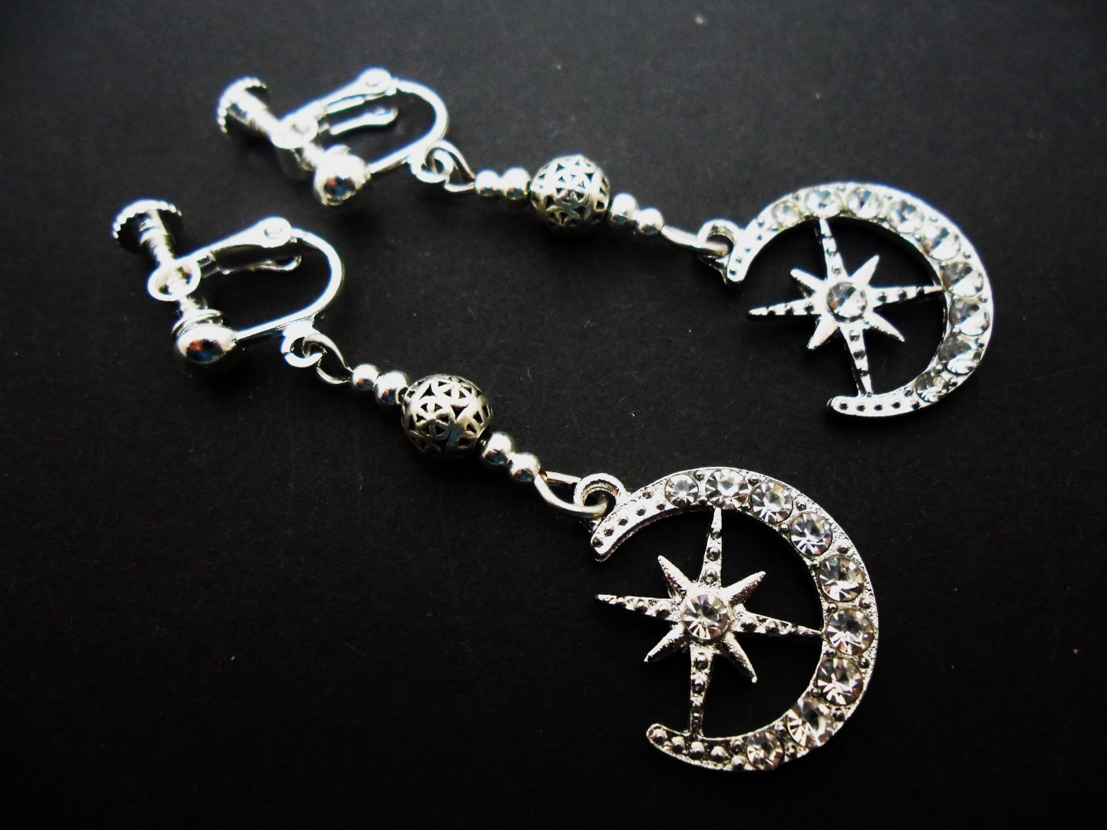 A PAIR DANGLY DIAMANTE MOON SCREW BACK CLIP ON EARRINGS. NEW