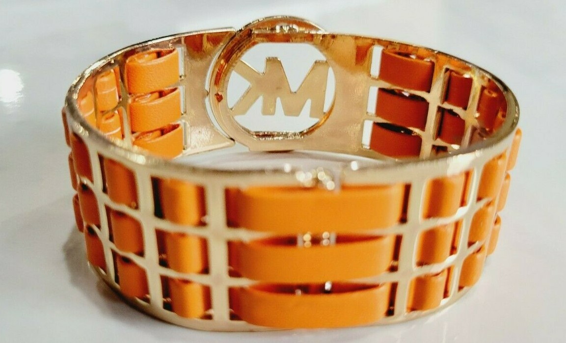Michael Kors Orange Leather Gold Tone Hinged Cuff Logo Bracelet.