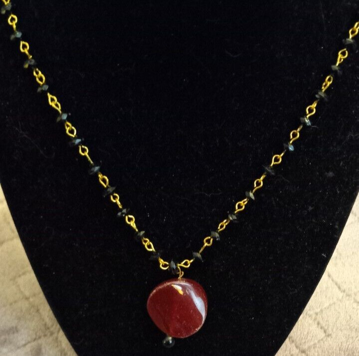 Gold And Black Necklace With A Red Glass Stone Pendant 22″